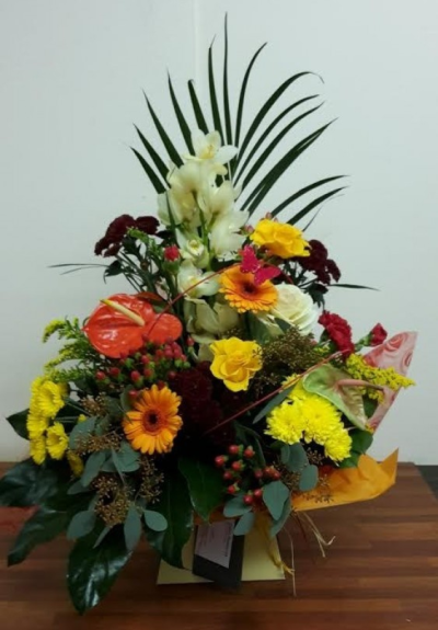 Sunny Delight - Beautiful fresh cut flowers arranged in a castle box in colours of yellows oranges and reds. 
