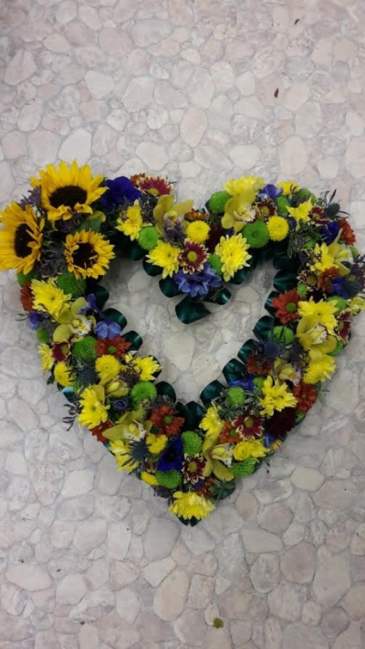 Bright mixed open Heart - A beautiful bright mixed open heart tribute. Call us for more information on T: 01948 661111 for more information on this product for sizes,  flowers and prices. 

15 " Start from £90.00

18" Start from £120.00

21" Start from £150.00 

Please choose the amount for the size you wish the product to be.