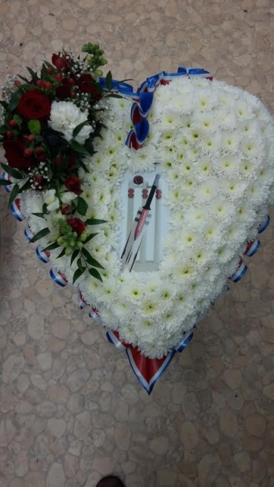 Cricket Heart Tribute - A beautiful red rose heart tribute with a Cricket picture in the centre . Call us for more information on T: 01948 661111 for more information on this product for sizes,  flowers and prices. 

15 " Start from £90.00

18" Start from £120.00

21" Start from £150.00 

Please choose the amount for the size you wish the product to be.
