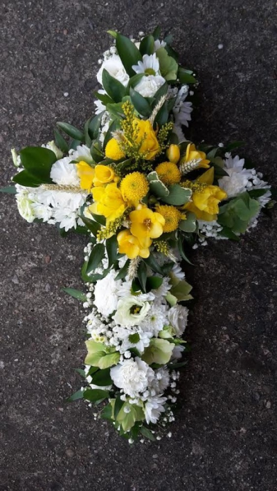 Yellow and White Cross - A beautiful cross made up with yellows and white flowers with greenery. Please call us on T:01948 661111 for more information on this funeral product. 

2FT Cross starts from £145.00

3FT Cross starts from £180.00

4FT Cross starts from £220.00

Please choose the amount for the size you wish the product to be.