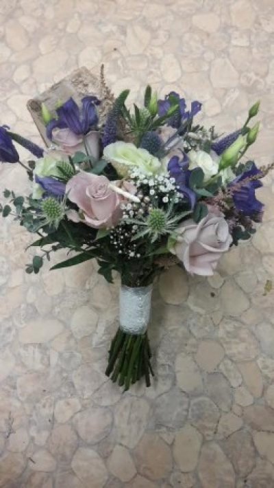 Rose and Thistle Bouquet - A stunning posy of fresh cut Thistles and roses and complementing filler. Call Gallery Flowers Whitchurch on T: 01948 661111 for more information on size and content for more idea of what to order. 

Please also give plenty of notice so we can make sure we have the correct fresh flower content for your bouquet.