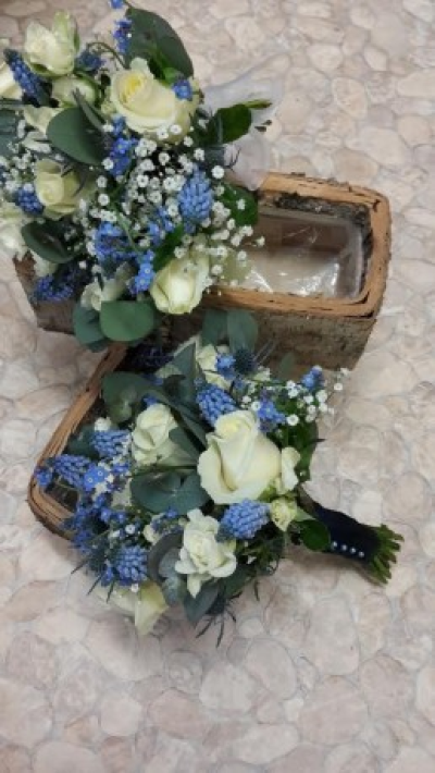 Blue and Cream Posy - A beautiful posy hand-tied in blue and creams. Please call Gallery Flowers for more information on flower content and sizes. Also provide plenty of notice so we can get the correct fresh flowers for your bouquet. 

Call us on T: 01948 661111